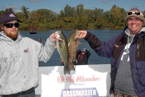 Winners Danny Jones and Jeremy Limerick toast each other with a largemouth and a smallmouth that total 8 pounds even.