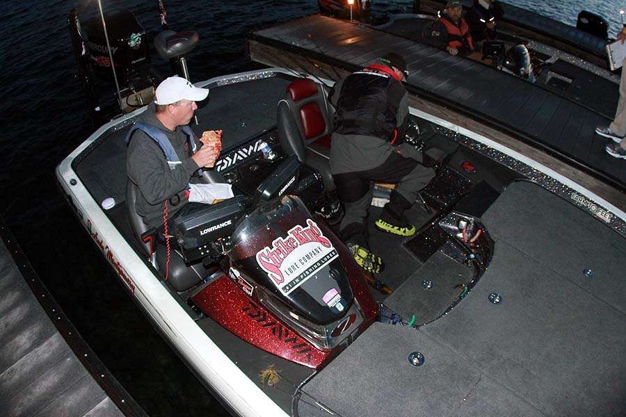 Andy Montgomery has breakfast on the go as he readies for the day to begin on Lake Norman.