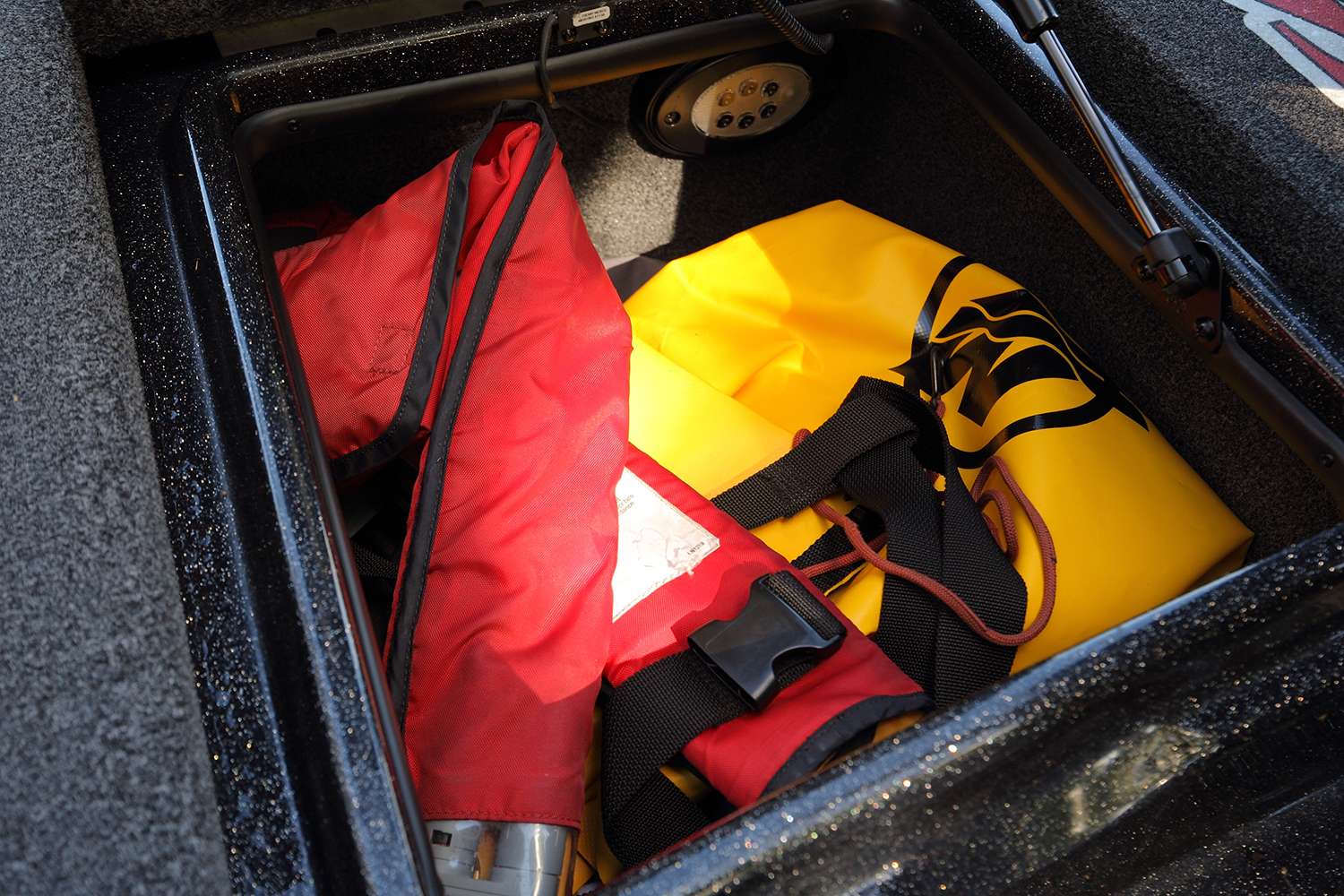 Inside the right rod locker, VanDam stores an Under Armour rain jacket, a life jacket, a sweatshirt and dry bag that he uses for his phone, wallet and important paperwork.
