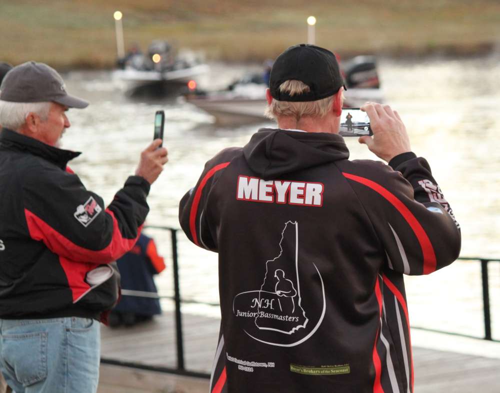 Fans take photos of their favorite competitors as they head out on the Ouachita River.