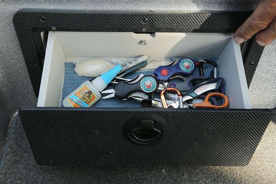 In this little glove box in front of the passenger seat are pliers, clippers, cutters, Boomerang snips.