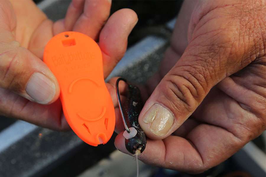 This is a Bait Button. It's used to keep trailer hooks on and can also keep worms on the hook, like this. You rig like normal, then slide the Bait Button on to secure the plastic.