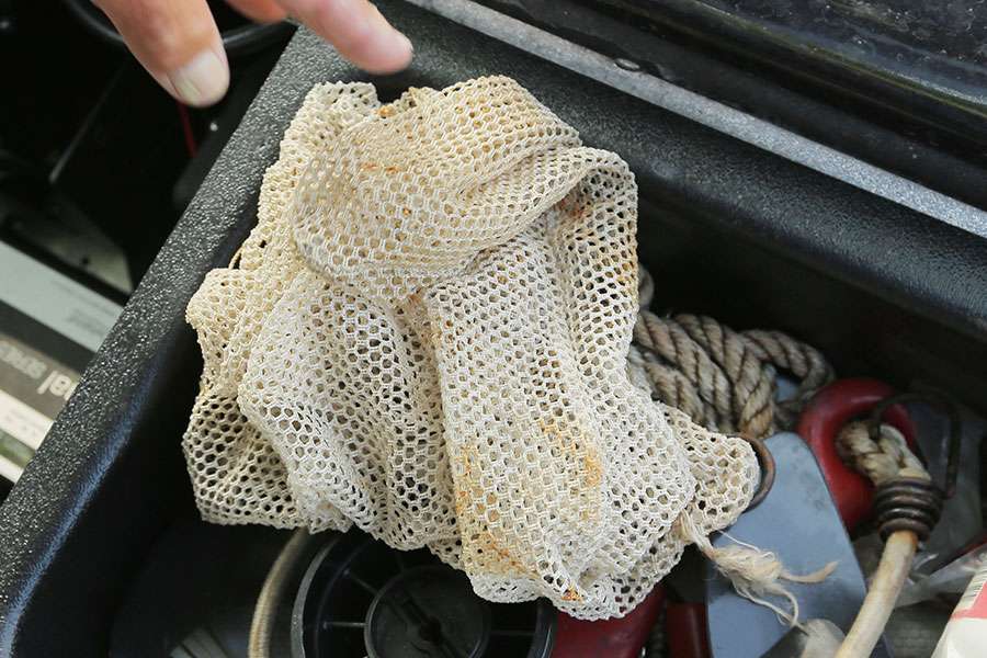 Here's an anchor and anchor rope. The mesh bag is in case he ever breaks down and has to hitch a ride with another angler. He can simply put his fish in the bag and toss them into his rescuer's livewell.