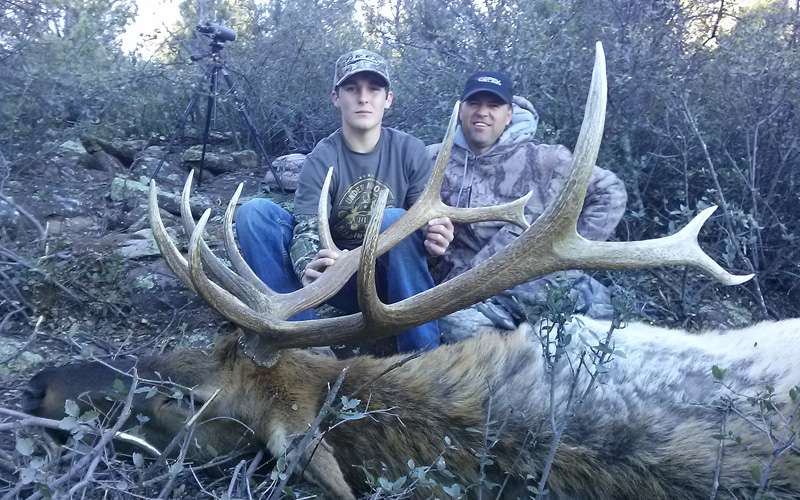 Jack Sweeney poses with Pirch next to an elk hunted in November.