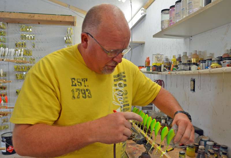 You got it, paint. Hunt works the airbrush over some crankbaits.