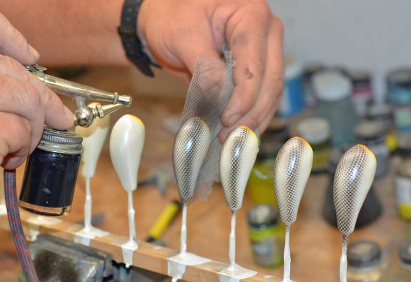Once they're dry, they're ready for detail. Ever wonder how handmade baits get scales? Wonder no more.
