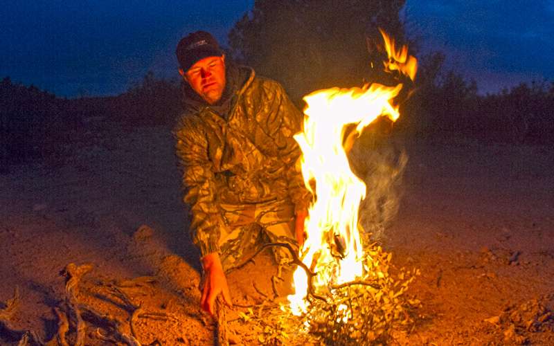 After the hunt, he will often light a fire to knock the chill off the cold nights in Arizona while he waits for his hunters to return.