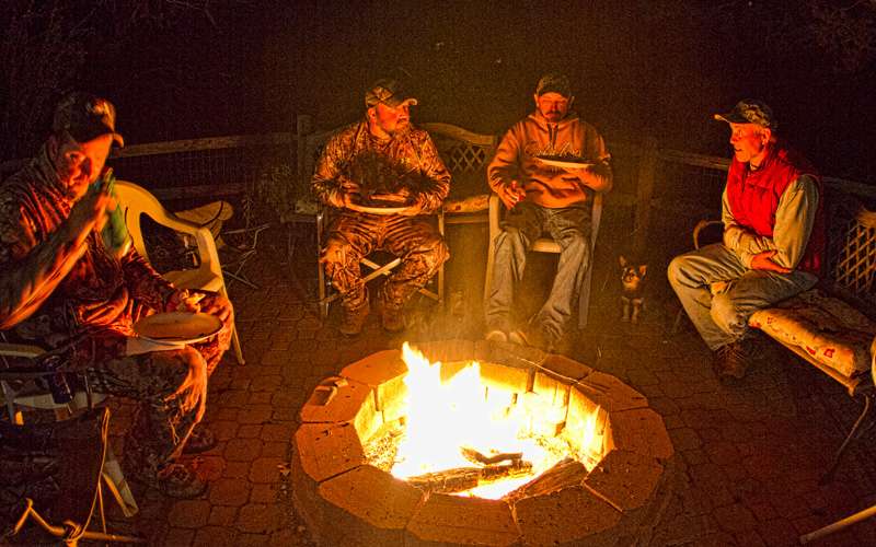 Pirch's father (far right) entertains those around the fire.