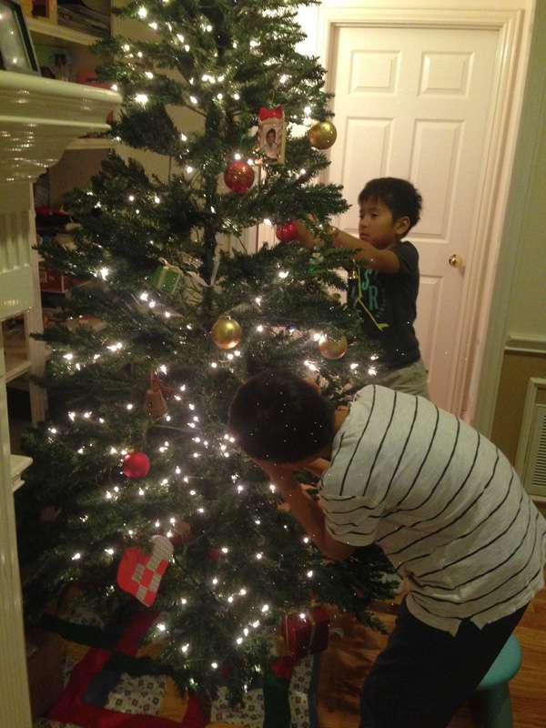 Yusuke Miyazakiâs sons, Tomoki and Takumi, help decorate the tree in their Texas home. Their love of Christmas slightly postponed a practice trip to Lake Havasu. 