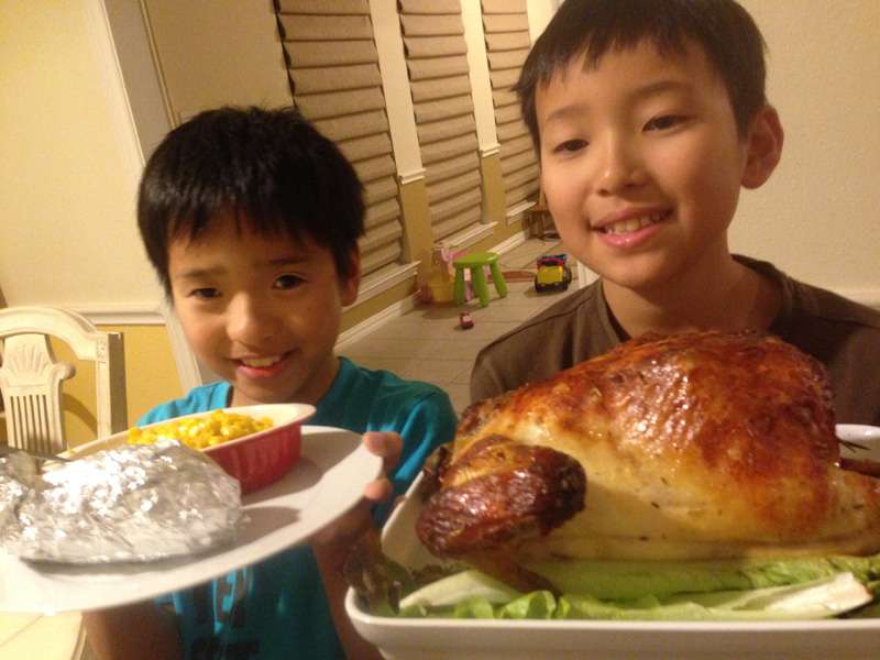 Tomoki and Takumi show off a roasted chicken, the traditional Christmas fare of the Japanese, although many enjoy fried chicken because of a clever KFC marketing ploy.