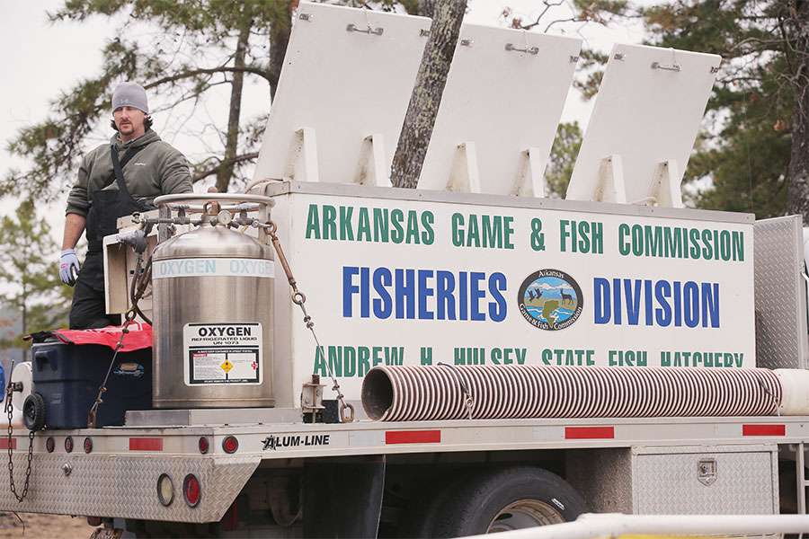 The Arkansas Game and Fish Commission stand at the ready, waiting for the fish to come off the stage.