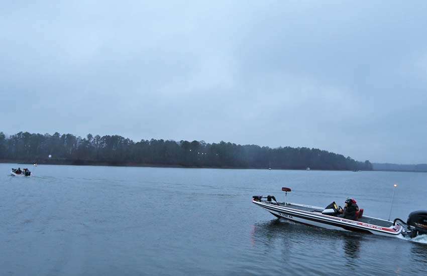 The first boats head out on DeGray Lake on the gray, dreary day.