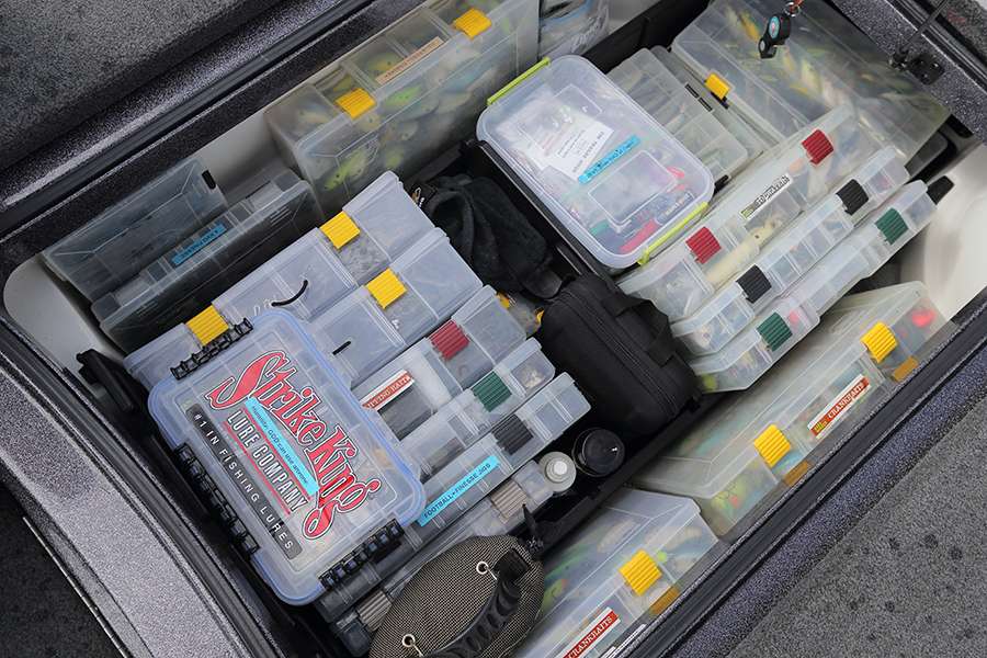 The center box holds tackle including various hard baits and plastics. They are stored in Cabela's plastic bins.