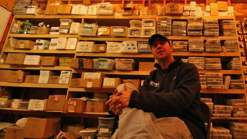 Faircloth talks about his career in front of a wall of boxes that hold everything from Senkos to lizards to grubs sorted by size.