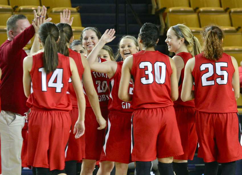 Ali Christie, second from right, celebrates with her Fort Gibson teammates and coaches after Zoe Shieldnight hit a near-halfcourt three-point shot at the halftime buzzer against Sterling. Fort Gibson made 13 of 19 three-pointers in the game.