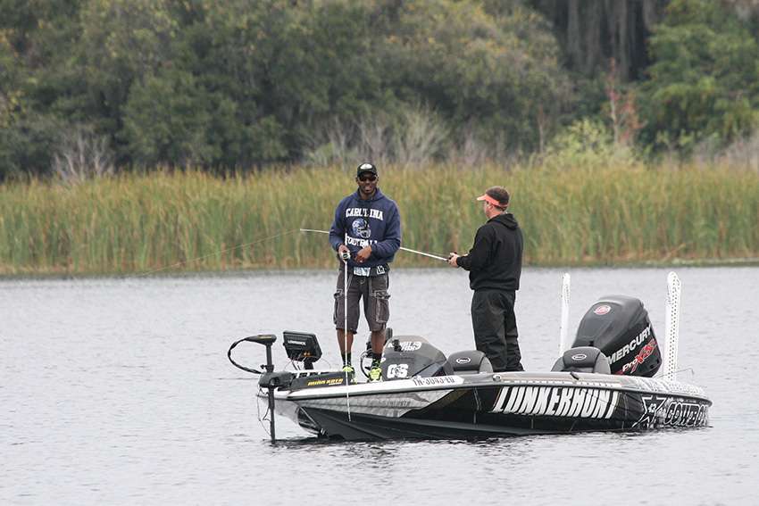 Former NFL player Gerald Sensabaugh fishes nearby.