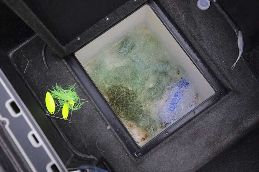 The storage compartment in the floor holds used fishing line. 