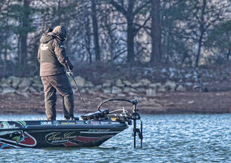 Most of the anglers assumed a familiar pose. Hunched over their electronics with rods angled down, looking for fish as Brett Hite is doing.