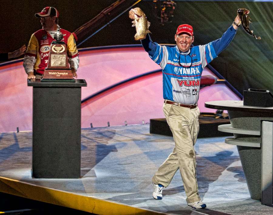 He gave a quick walk about the stage, fish in hand, while Boyd Duckett waited to hand him the trophy.