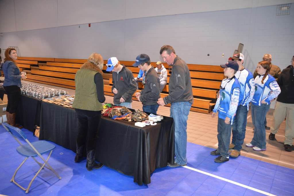 Anglers made their through a row of tables, picking up merchandise from various sponsors. At the end of the line, they completed their paperwork and paid their entry fees.