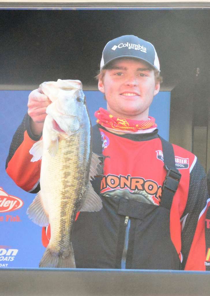 Justin Barnes of the Monroe Student Bass Anglers holds one of the bigger largemouth caught during the event.