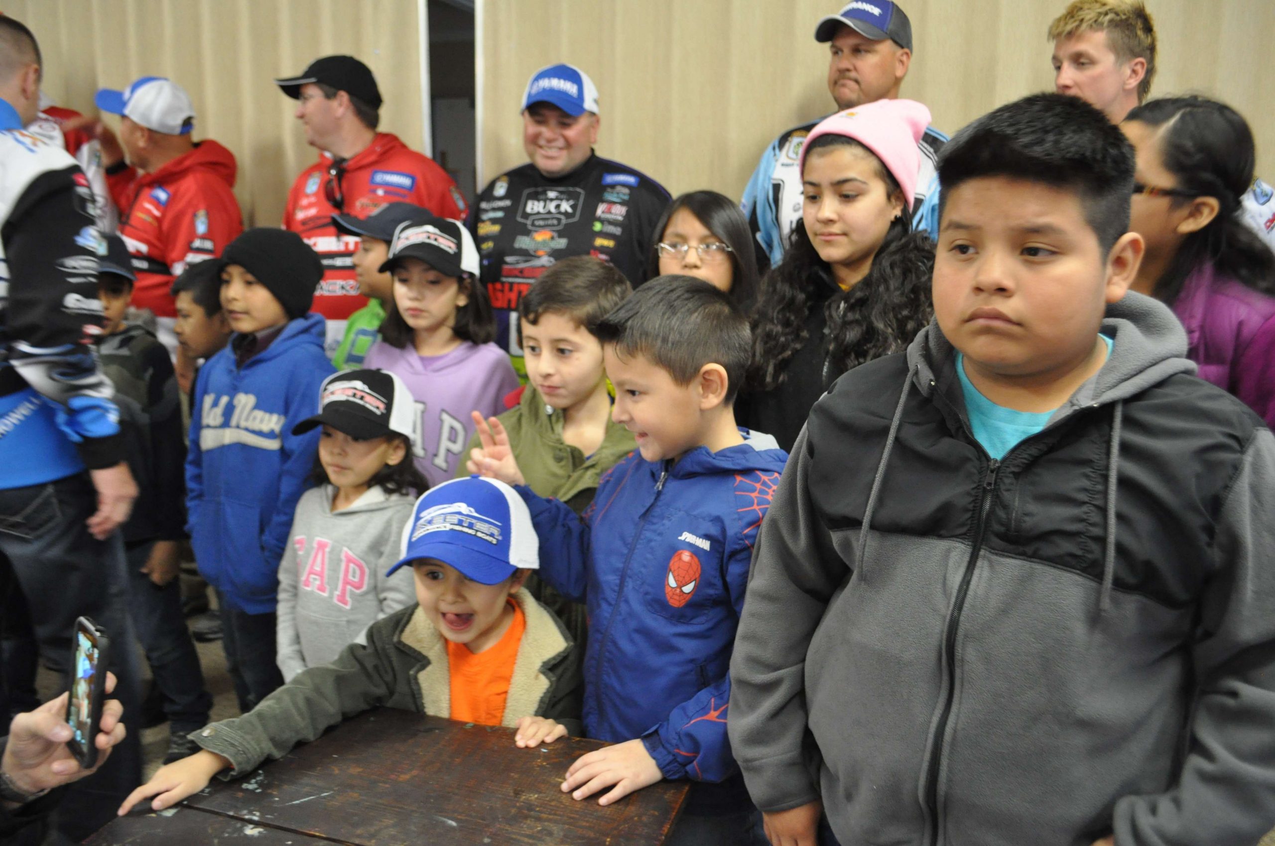 The children get ready to pose for a group picture with the anglers.