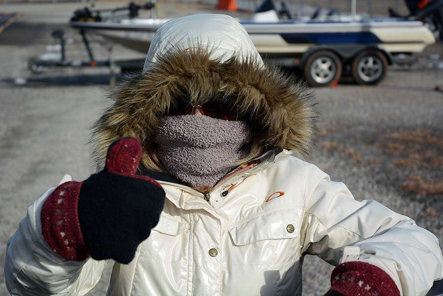 LeAnn Swindle is all bundled up for the occasion as husband Gerald prepares tackle for the competition. 