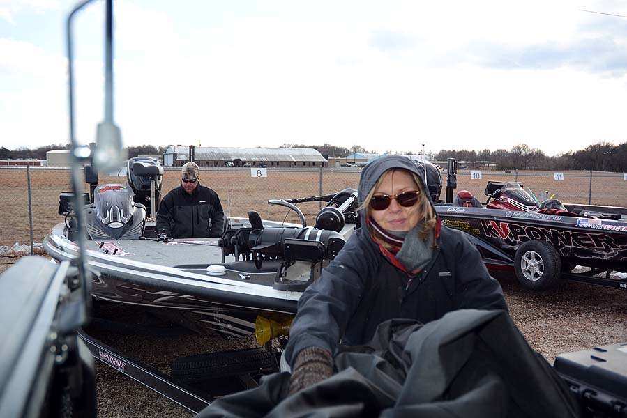 Debbie Morgenthaler pitches in to help husband Chad with covering the boat.