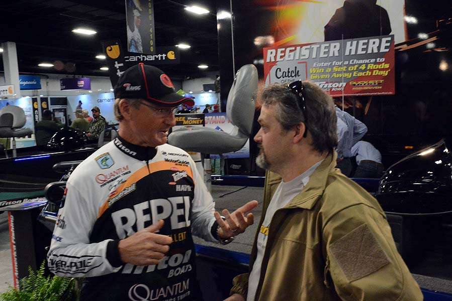 Gary Klein talks serious fishing with a fan in the booth at Triton Boats. 