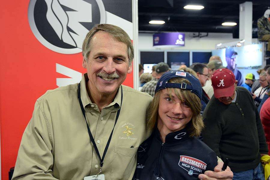 The legendary Hank Parker greets a Bassmaster High School angler in the Mercury booth. 