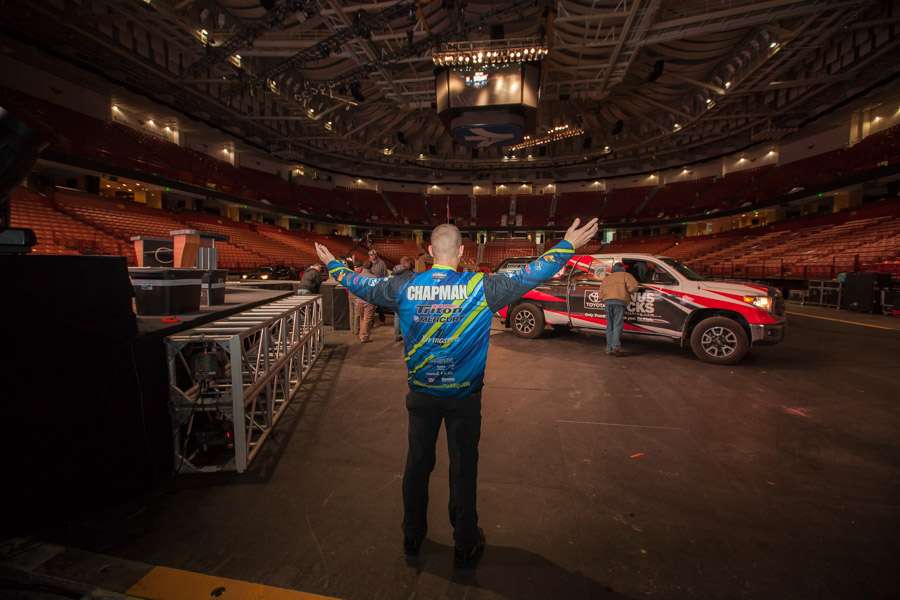 Chapman steps out onto the floor of the arena, where a truck and boat are part of a technical run-through to test before the show begins.