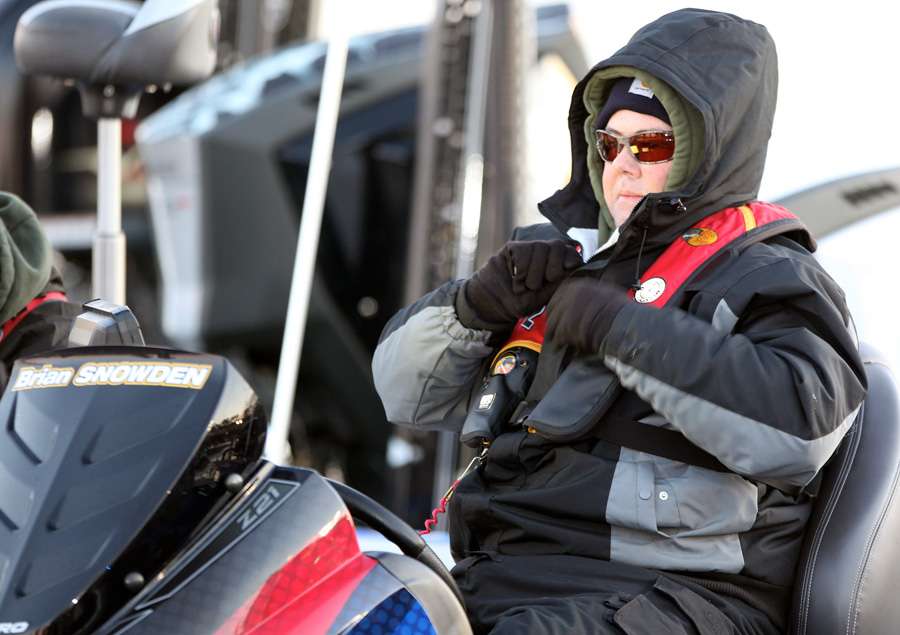 Brian Snowden makes sure one last time that everythingâs strapped down tight, for a cold, early morning boat ride. 