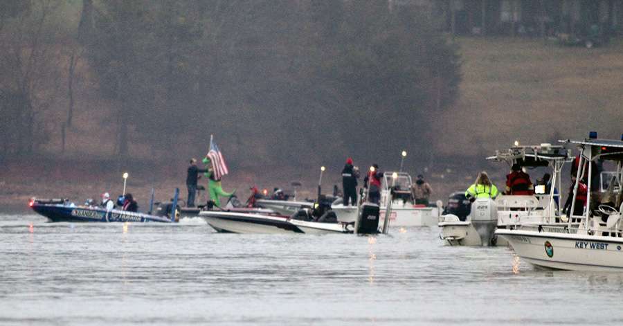 A flotilla of spectator boats looks on as Day 1 leader Dean Rojas makes his way onto Lake Hartwell. 