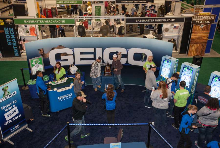 At the GEICO booth fans pose with the GEICO Classic trophy. 