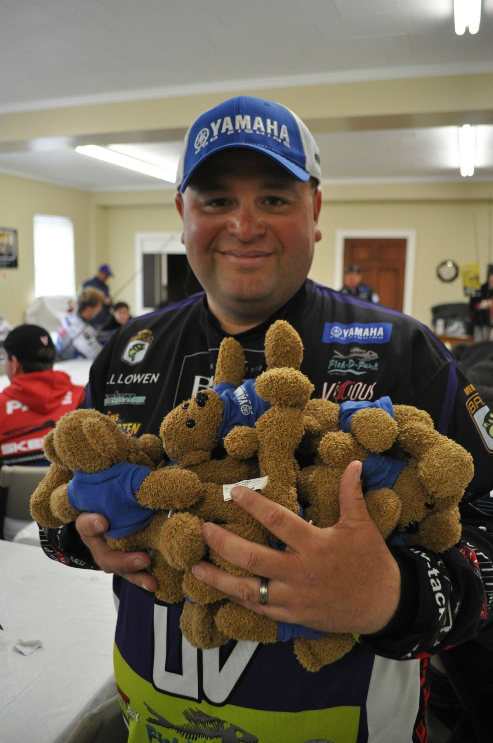 Bill Lowen grabs a handful of Yamaha teddy bears to distribute to the group. 