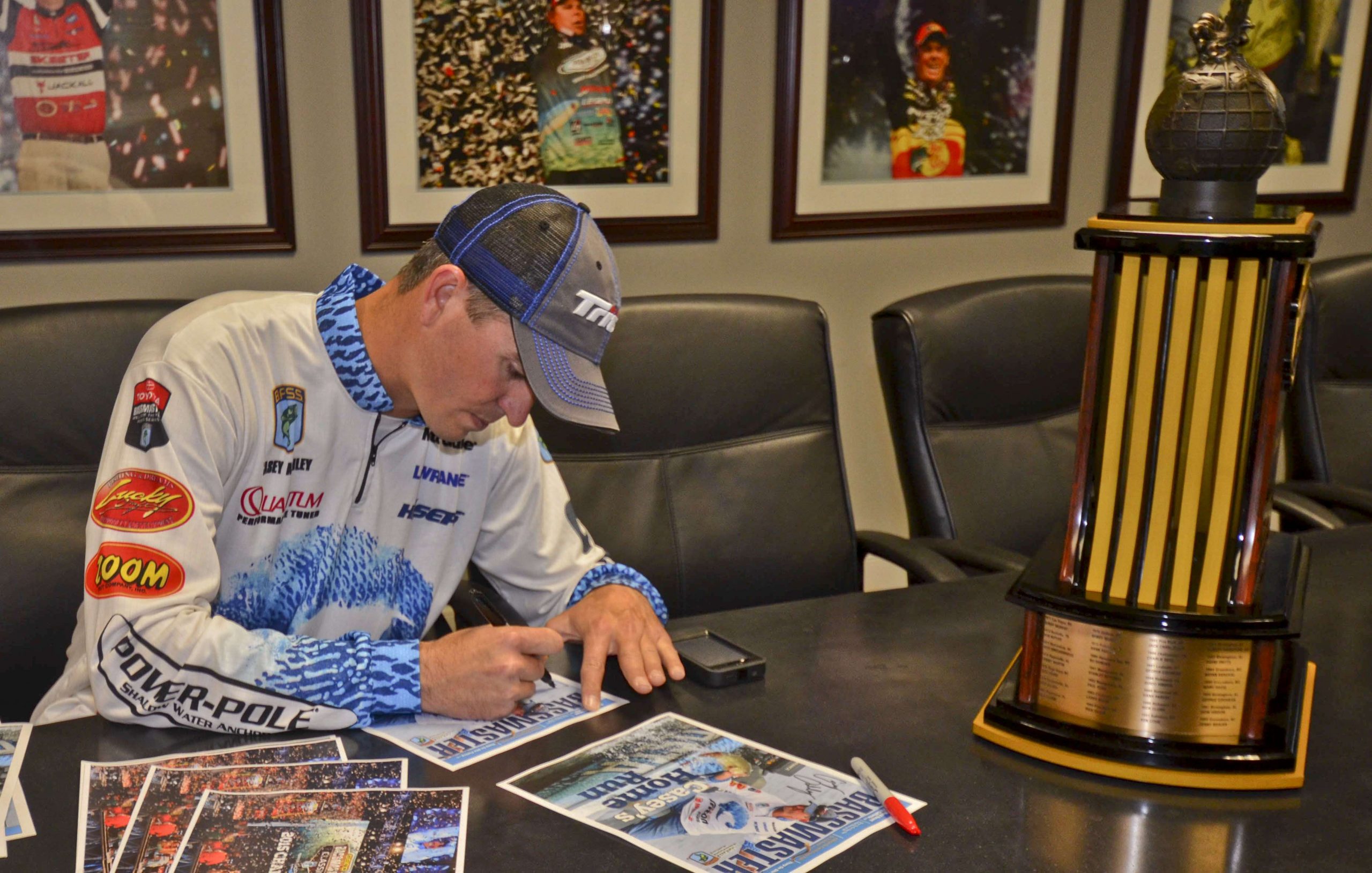 ... signing some of them on printouts of the yet-to-be-printed cover of Bassmaster Magazine, which he will be featured on.