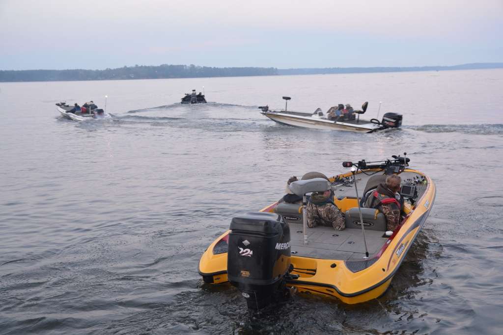 A group of boats leaves the park, including one in Skeet Reese-style yellow.