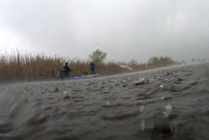 The rain is really coming down as Todd Faircloth fishes in the distance. 
