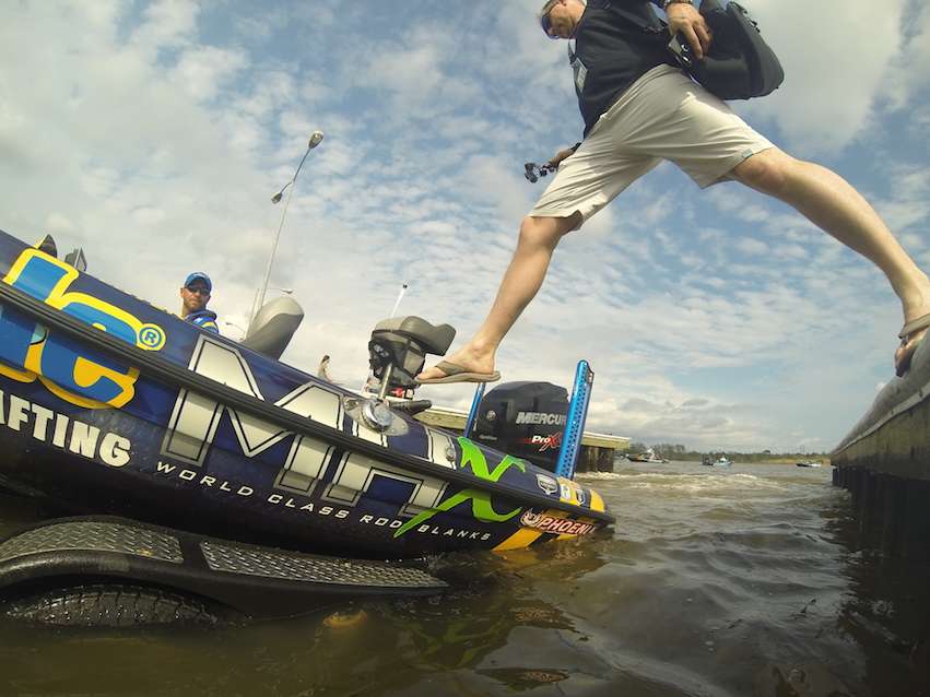 Chris Brown from Rigid Industries makes an athletic jump into Brandon Lester's boat.