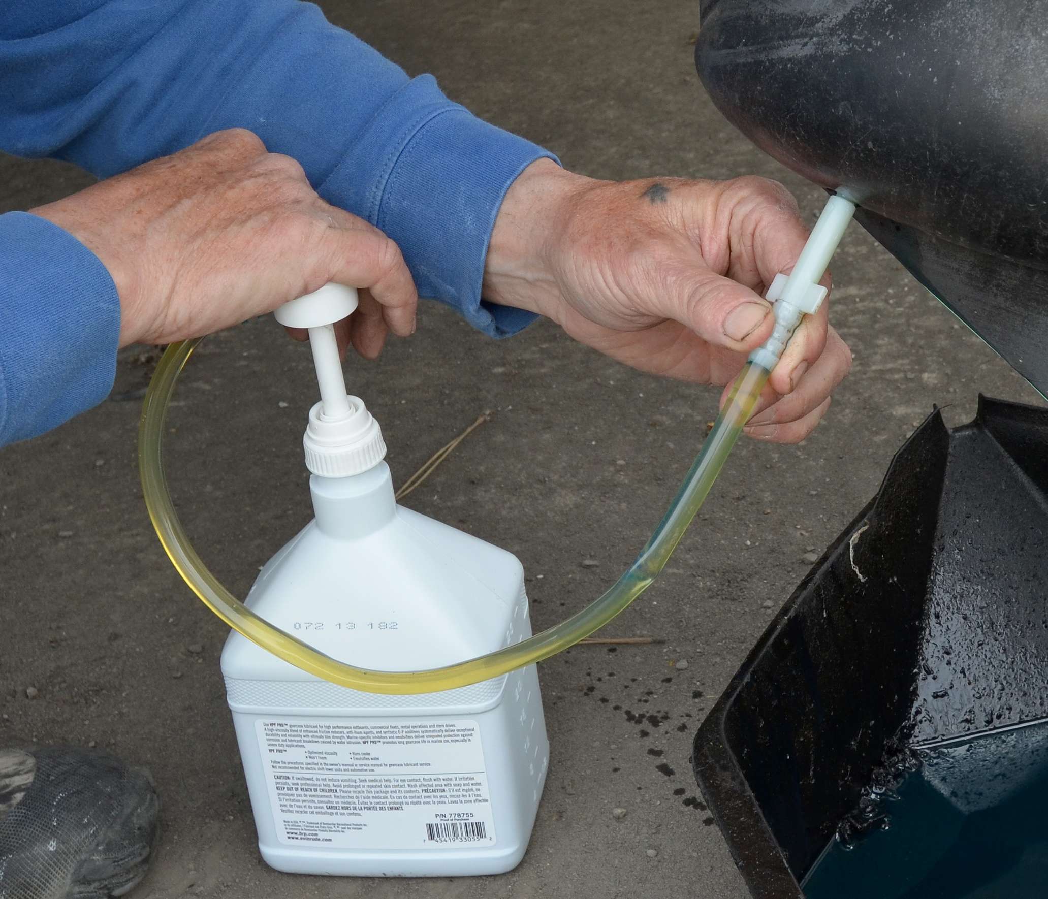 <em>CHANGING GEAR OIL</em>
<br>Buy outboard gear lube that comes with a pump. Insert the line from the container into the bottom hole. Pump the lubricant slowly into the lower unit to avoid creating air pockets.