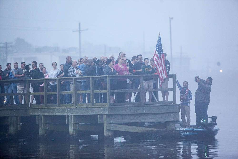 Hoping to make the fog cooperate, Casey Ashley sings the national anthem. It doesn't work, but it was a good rendition. 