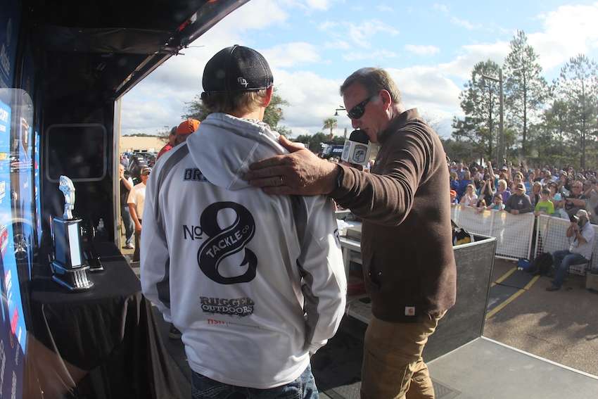 Brainard receives a pat on the back from B.A.S.S. Tournament Manager Chris Bowes.