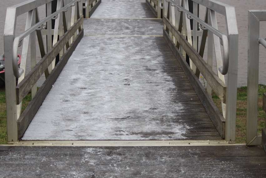 The walkway is iced over down to the docks. 