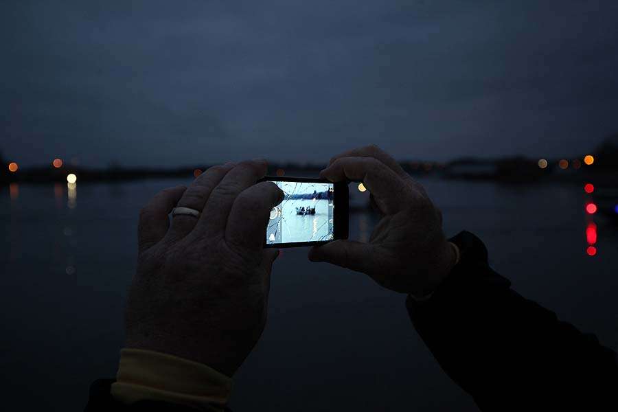 A fan takes a picture in the early morning at Madison Landing.