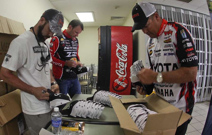 Terry Scroggins is joined by his fellow Team Toyota pros Kevin VanDam and Mike Iaconelli. They signed boxes of caps. 
