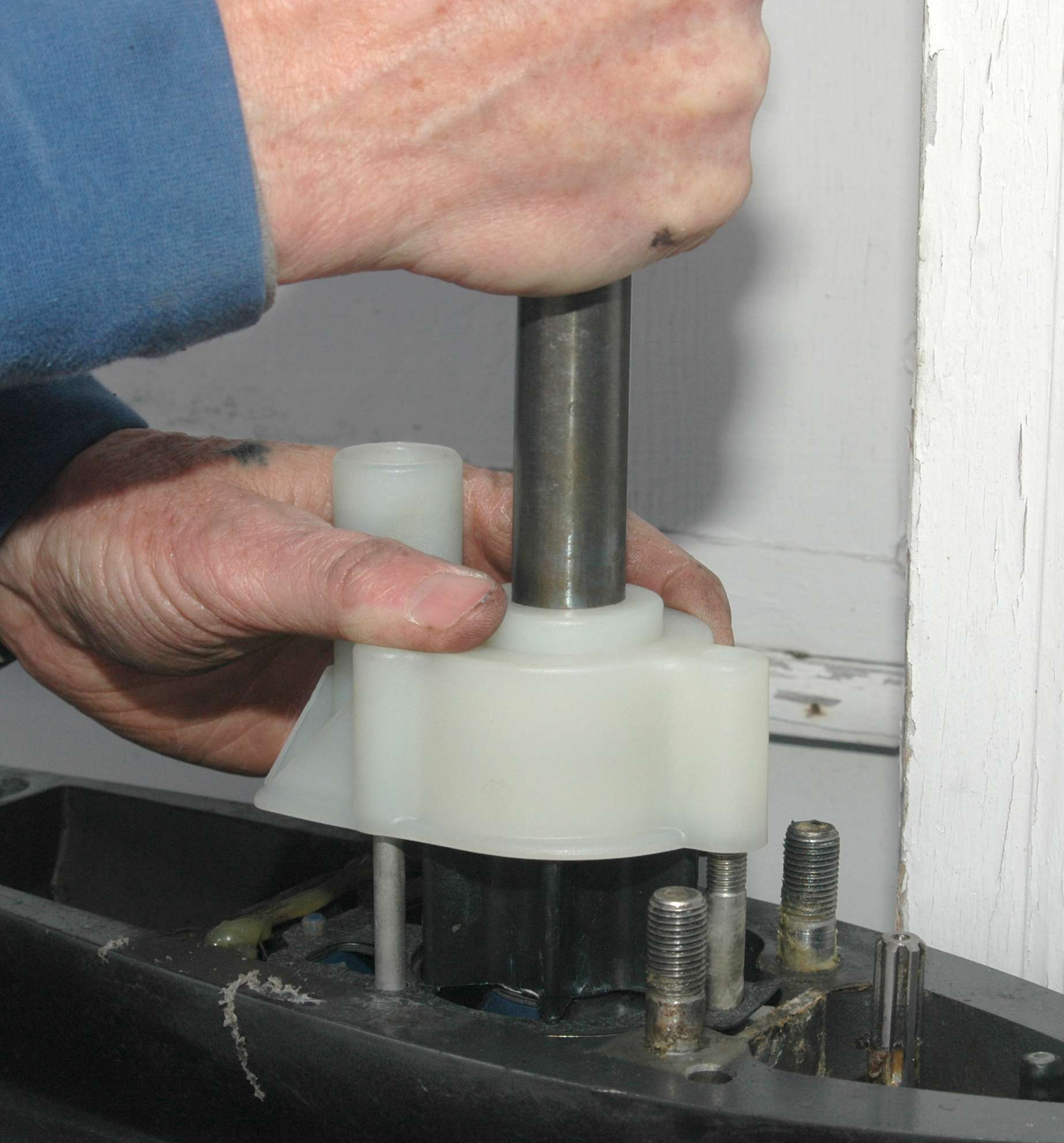 <em>REBUILDING THE WATER PUMP</em>
<br>Apply marine grease sparingly to the outside of the impeller and the inside of the water housing. Slide the impeller down the drive shaft and over its key. Then slide the water pressure housing down the shaft. Turn the shaft clockwise by hand while pressing down on the housing to bend the impellerâs arms into the housing.