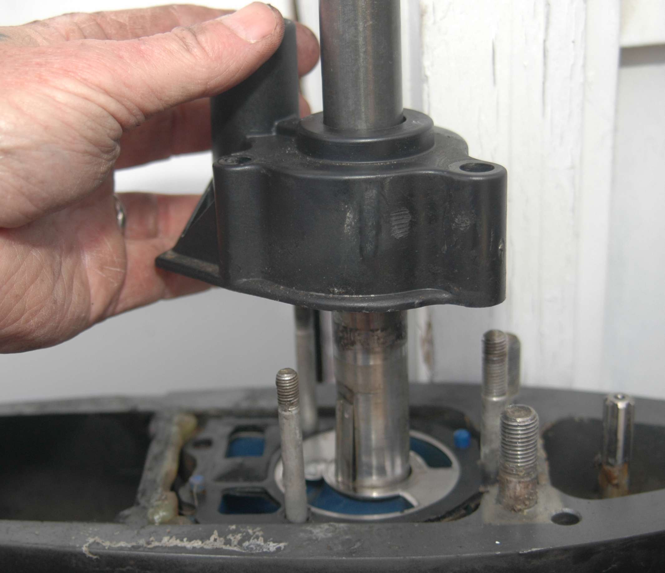 <em>REBUILDING THE WATER PUMP</em>
<br>After removing the nuts, slide the water pump housing straight up and off the drive shaft. The impeller typically stays inside the housing.