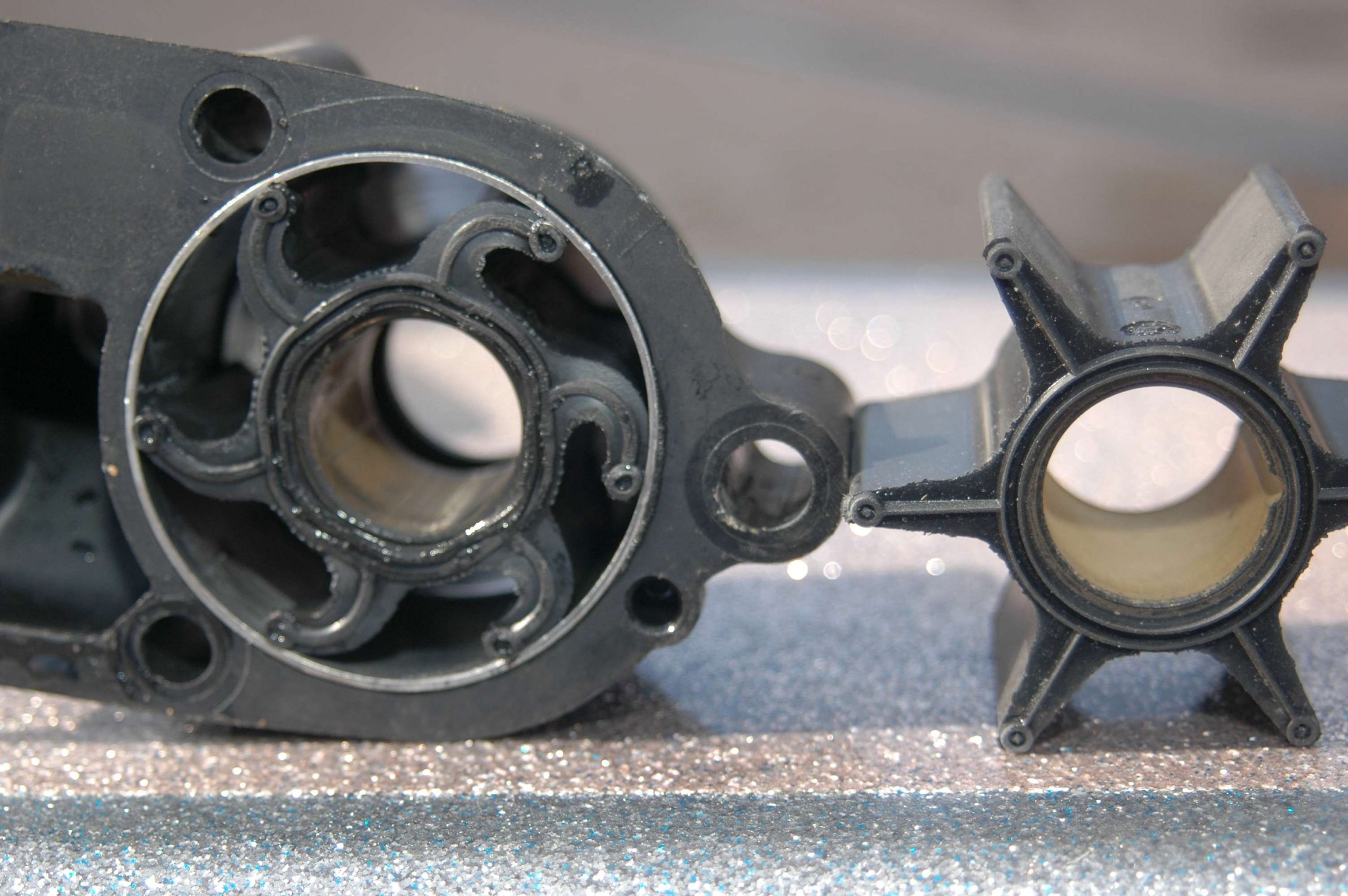 <em>REBUILDING THE WATER PUMP</em>
<br>The old impeller is on the left in its housing next to a new impeller. The rubber arms eventually wear out and lose their ability to drive water through the outboardâs cooling system.