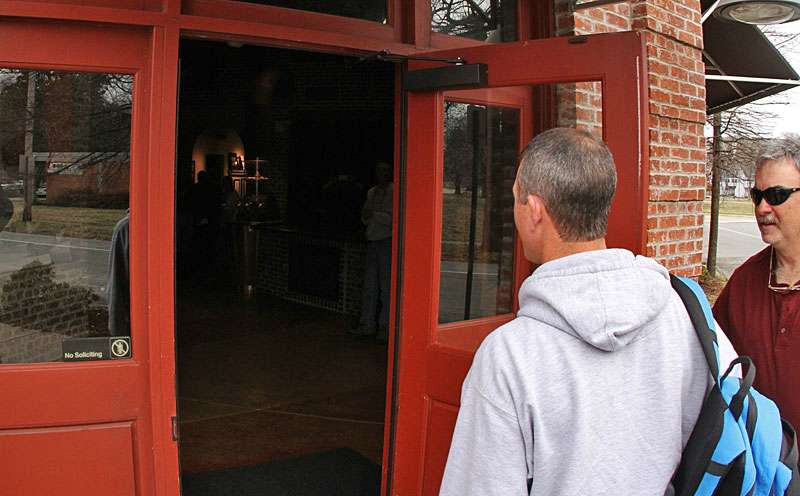 <p>Steve Bowman opens the JM Associates office door to allow Ashley to enter.</p>
