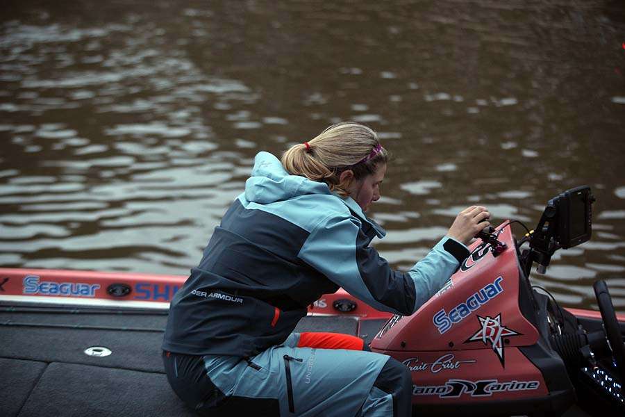 <p>Trait Crist tweaks a GoPro camera mounted on the console of her newly wrapped Under Armour/Skeeter rig. </p>
